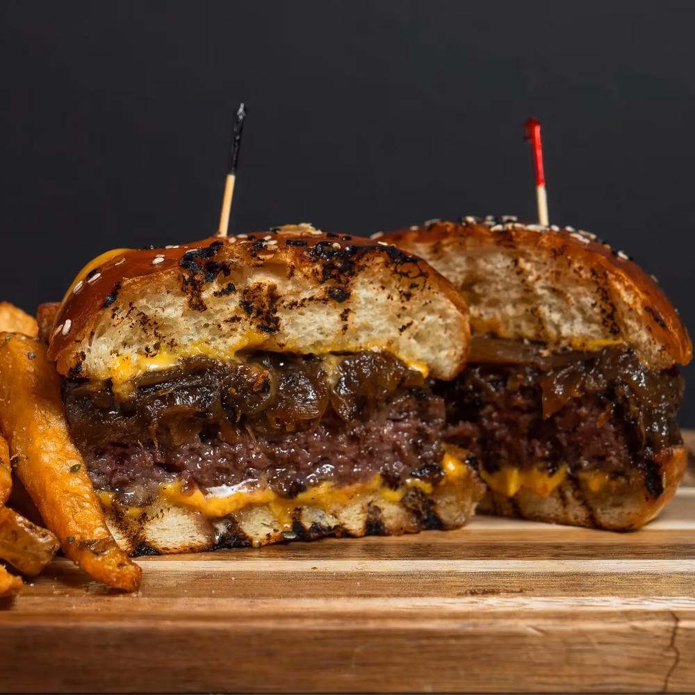 Close-up of a halal burger with melted cheese on a fresh-baked bun