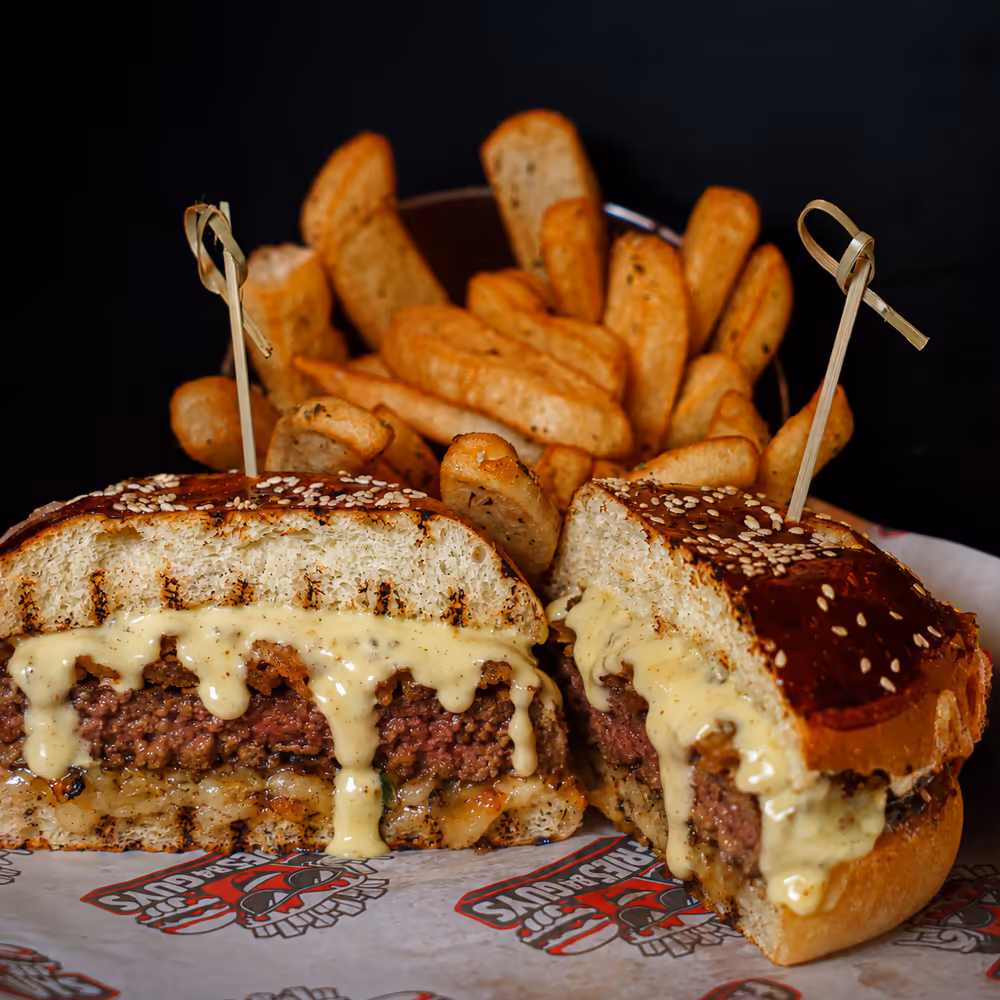 The Blue Royal cut in half with a basket of Dutch-style fries behind it
