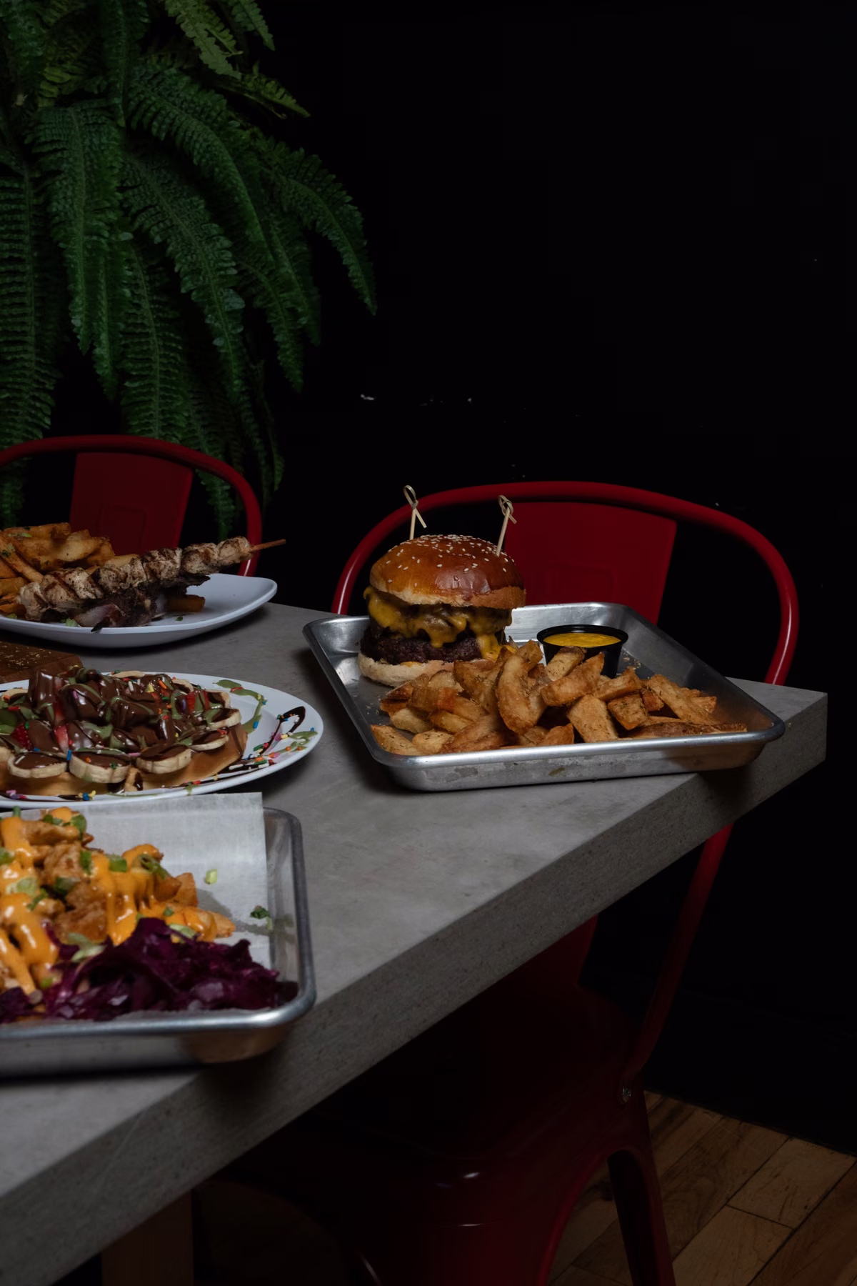 A burger and hand-cut Dutch-style fries on a tray in the dining room at FRIES B4 GUYS in Allston, Boston